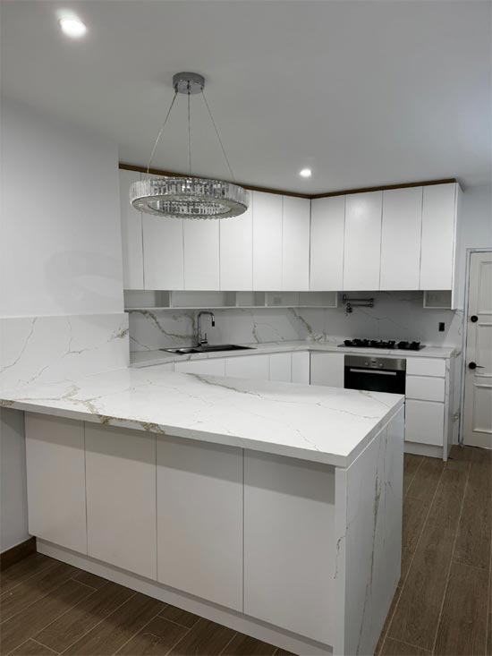 Completed kitchen with a marble waterfall peninsula