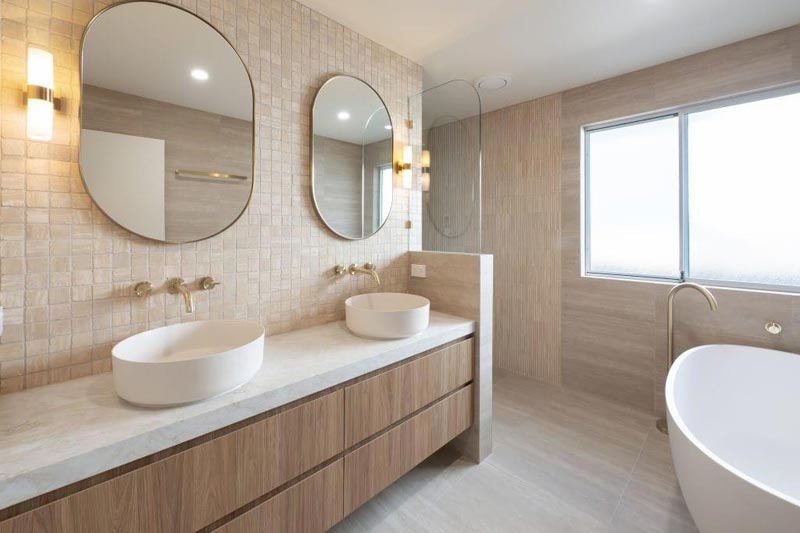 Completed bathroom with twin basins and a freestanding bath