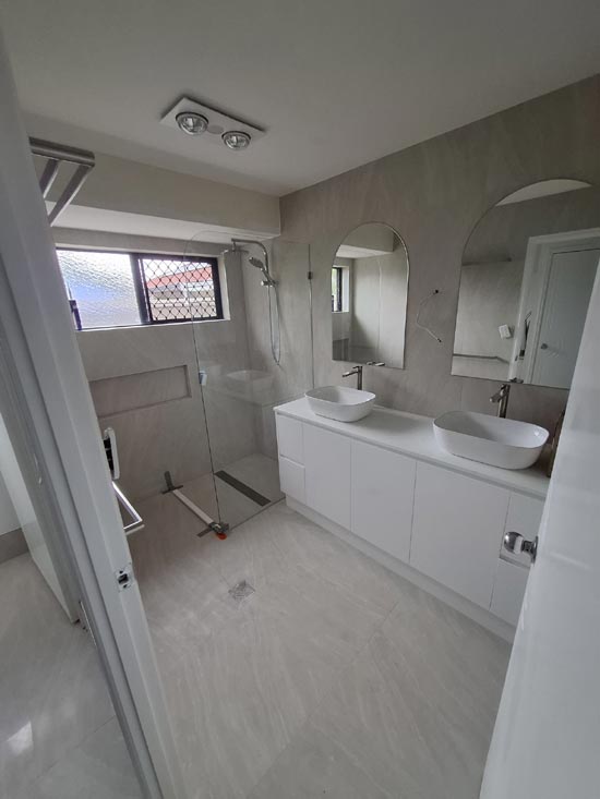 Completed bathroom with twin vessel basins and walk-in shower