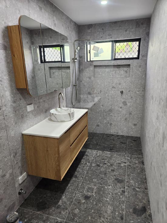 Completed bathroom with timber vanity and terrazzo floor tiling