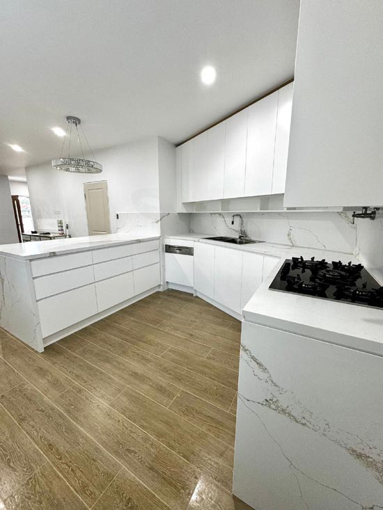 Completed kitchen renovation with a stone waterfall benchtop and gas cooktop