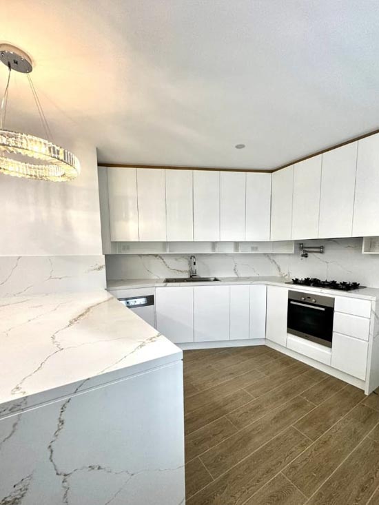 Completed kitchen with marble benchtops and wall oven
